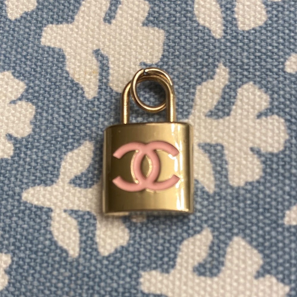 CHANEL charm Gold Padlock with Pink Logo ready to add a necklace.